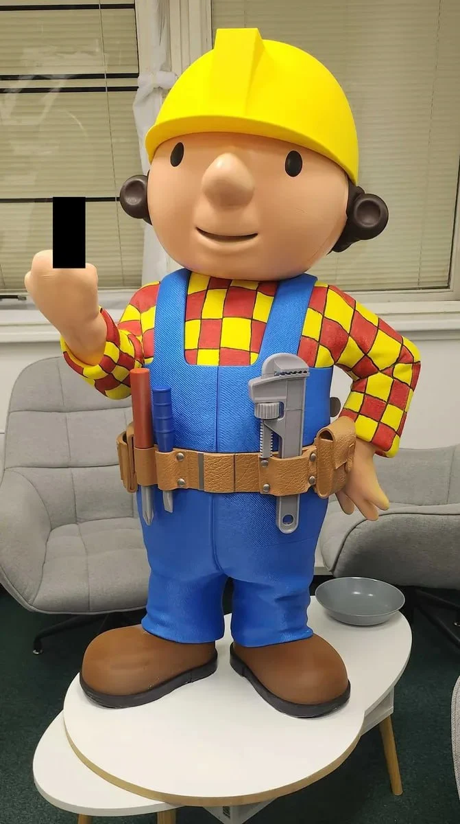 Bob the Builder character figure wearing a yellow hard hat, blue overalls and a tool belt