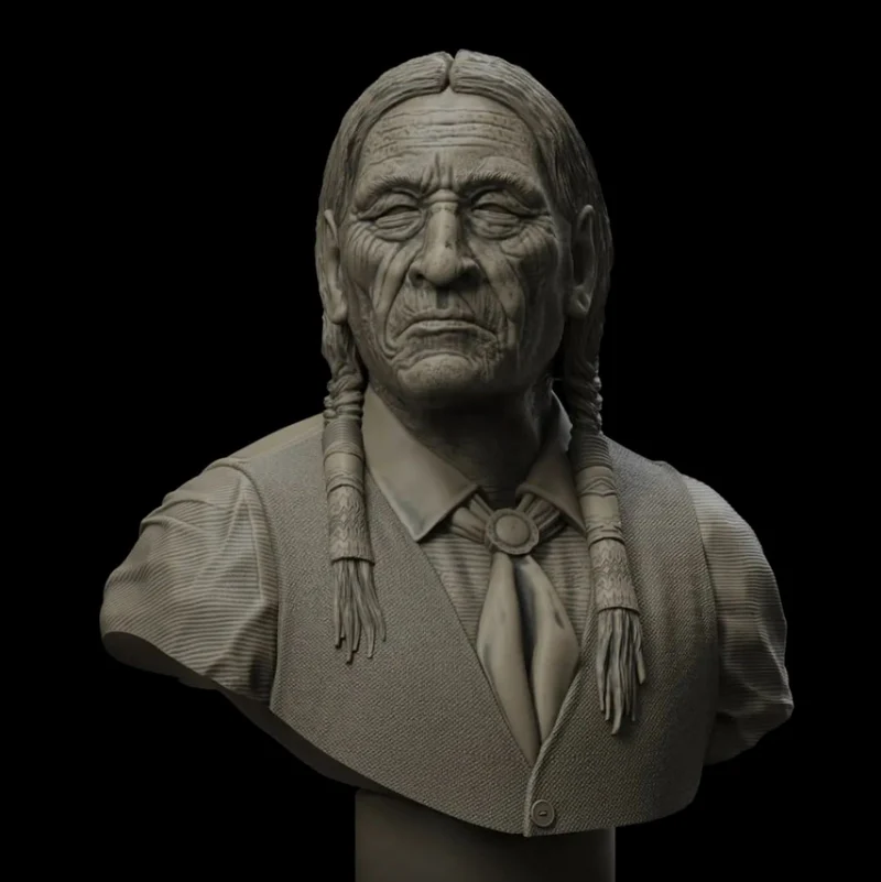Historical Cheyenne elder bust with braided hair, lined face, vest, collared shirt, and neckerchief