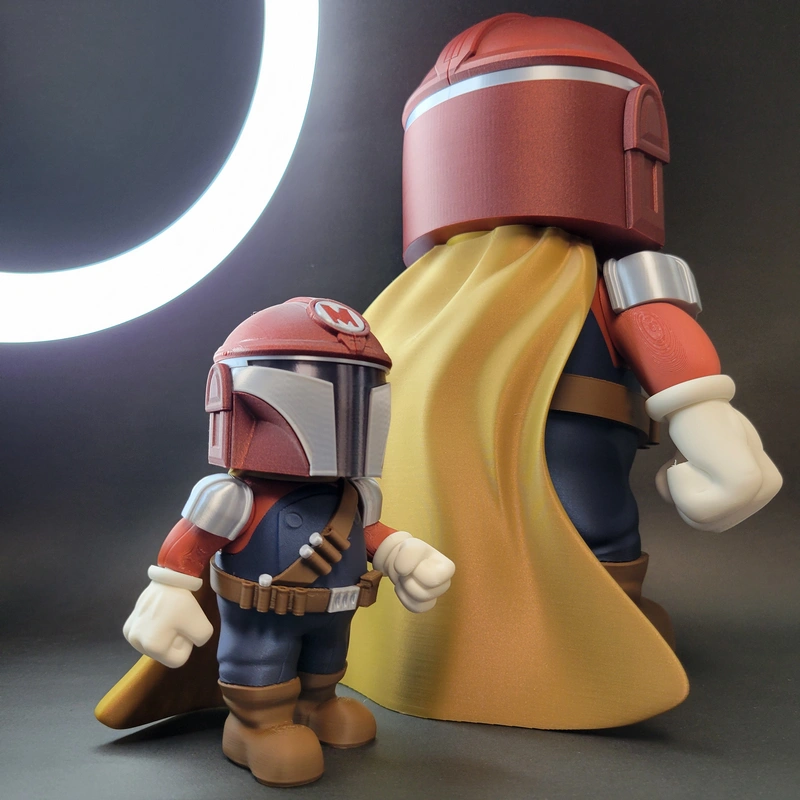 Two stylized Mario Mandalorian crossover figures with helmets and a yellow cape
