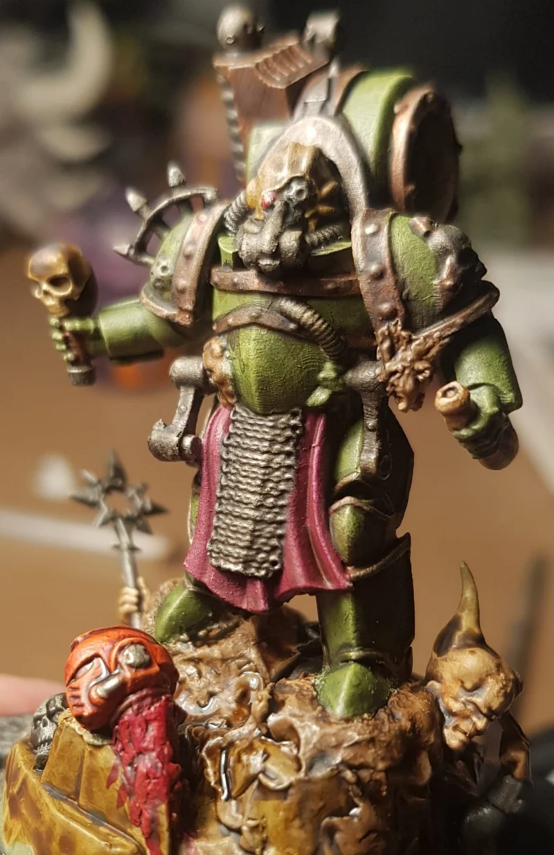 Painted sci-fi armored warrior figure with skull motifs and a staff