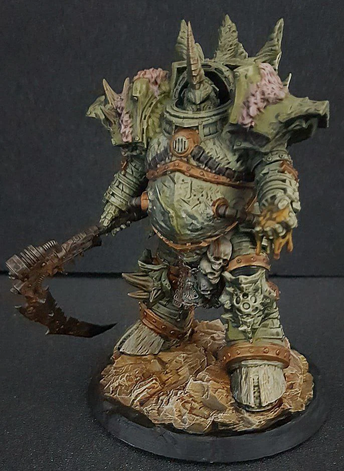 Typhus Warhammer 40,000 armored figure with curved scythe on a rocky base