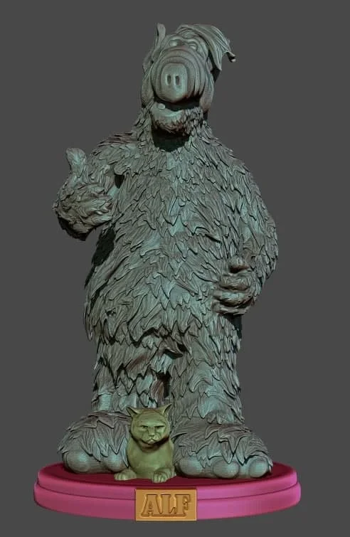 ALF character statue with a cat companion on a labeled display base