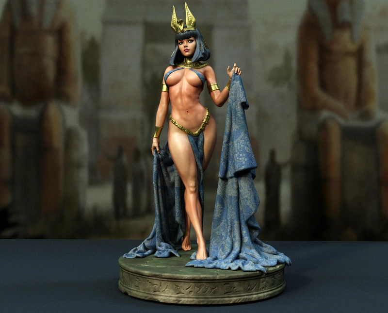 Cleopatra statue with horned crown, blue drapery, and Egyptian display base
