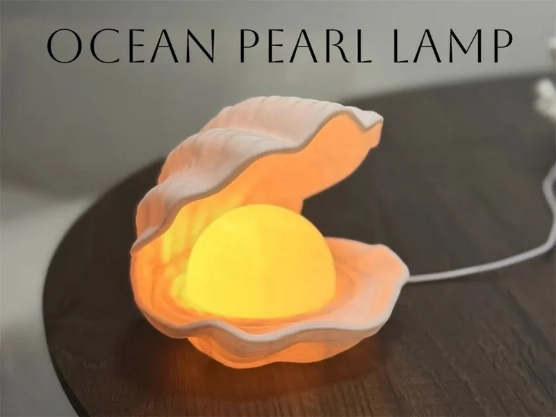 Open oyster shell lamp with a glowing pearl-like center