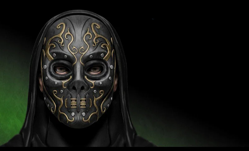 Ornate black Death Eater mask with gold scrollwork and a central grille