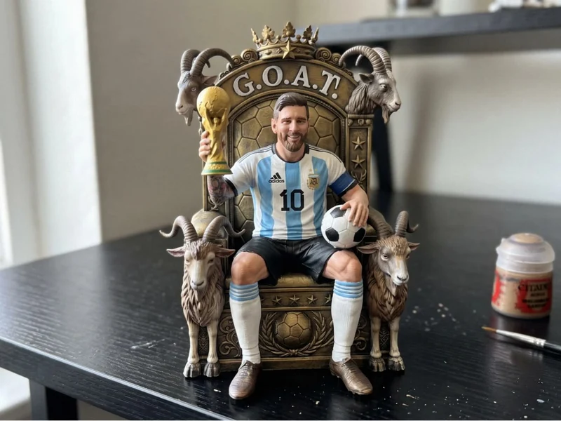 Lionel Messi football figurine seated on an ornate throne with goats