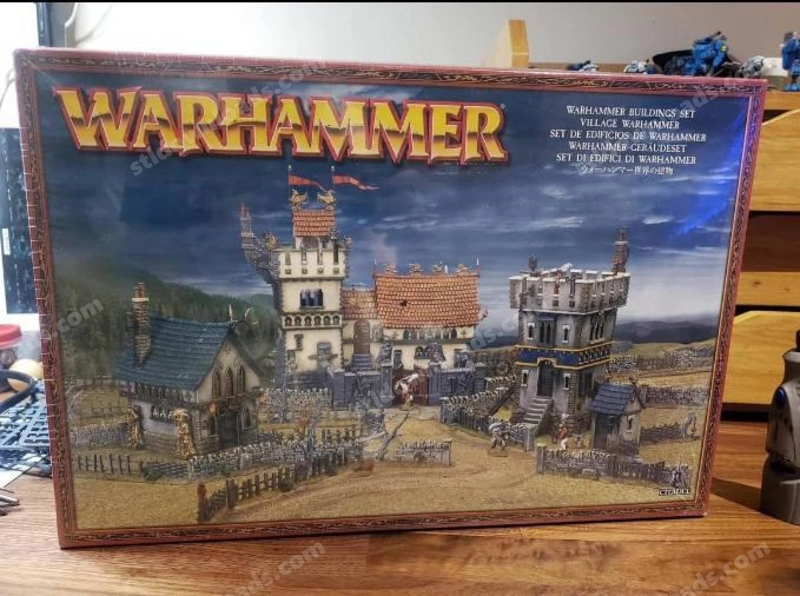 Warhammer fortified settlement with towers, walls, rooftops and village buildings