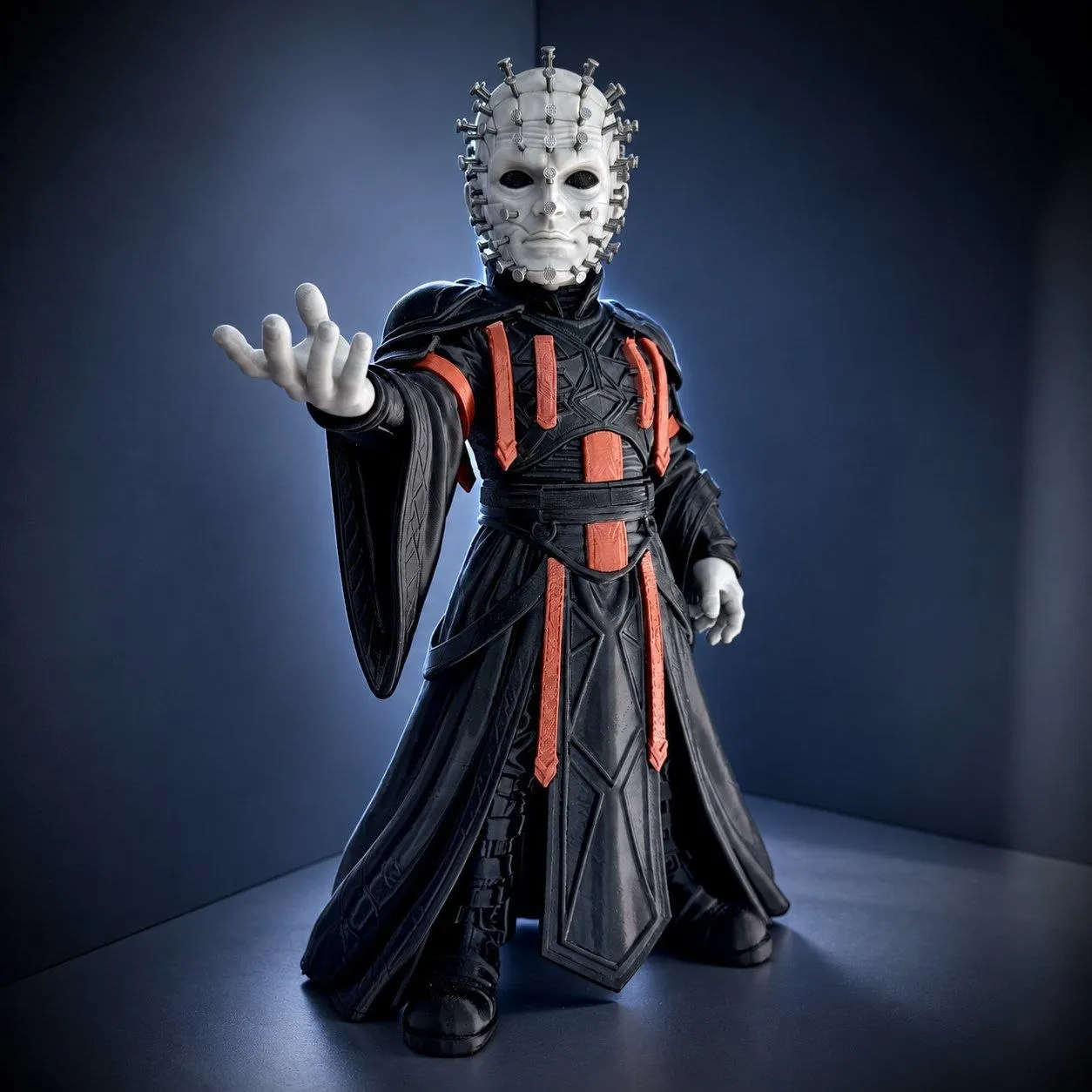 Pinhead Hellraiser figure with a nail-studded head and black red robe